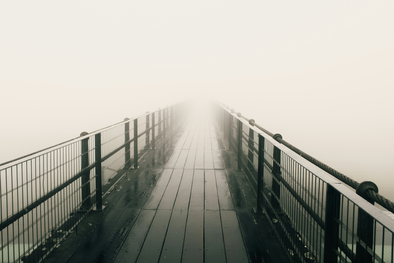 a dock that disappears into fog